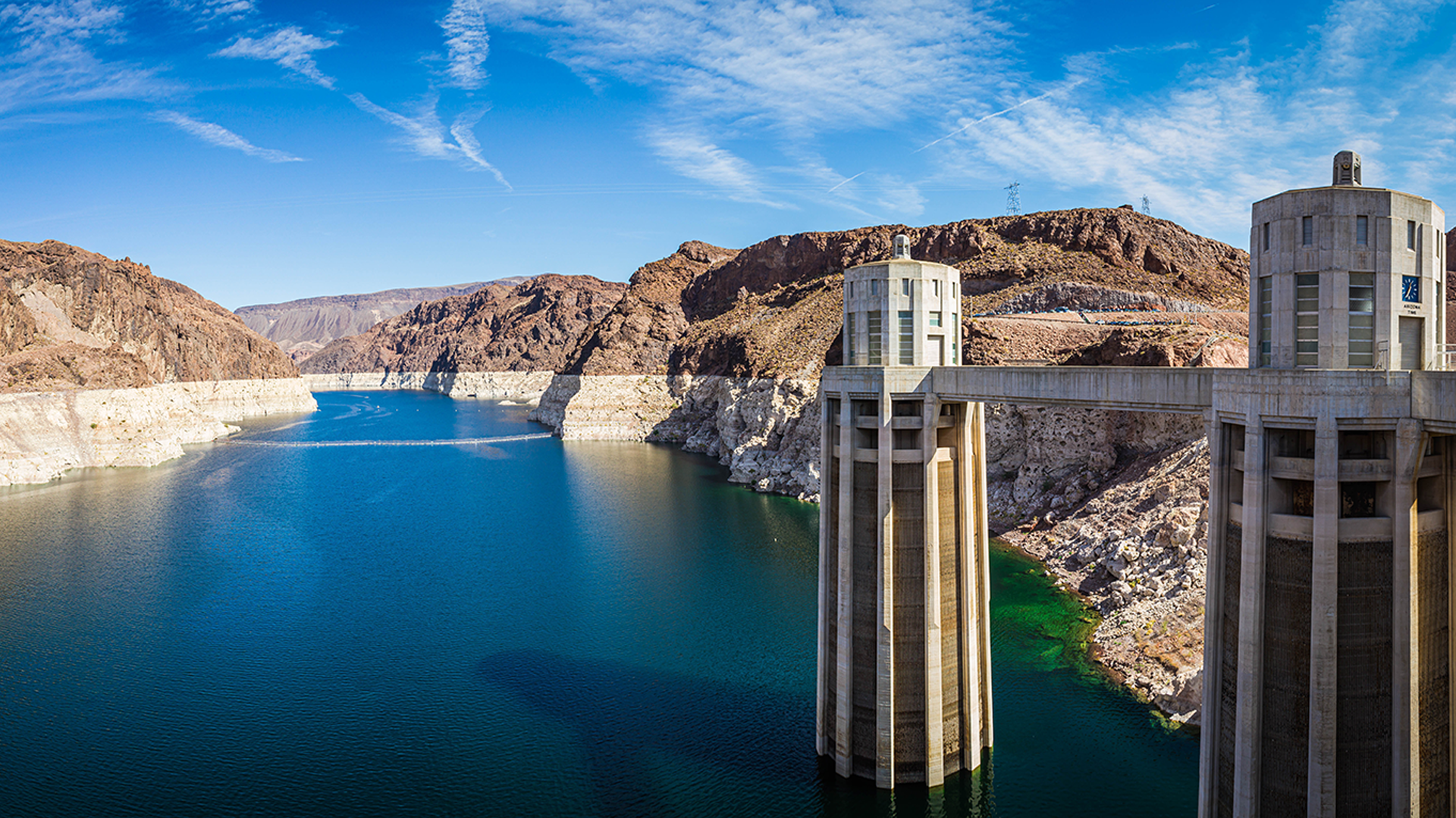 Hoover Dam intake towers with Lake Mead and surrounding desert canyon landscape