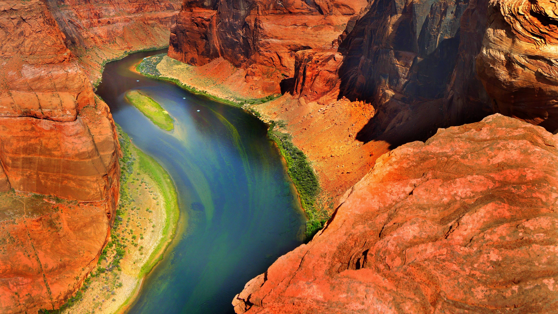 Colorado River winding through red rock canyon landscape viewed from above